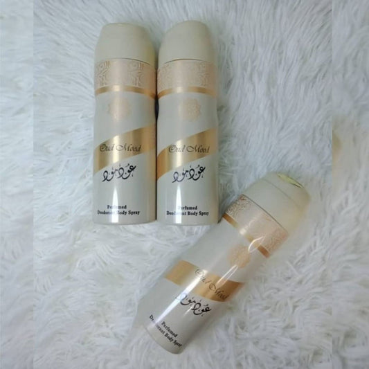 Oud Mood perfumed deodorant body spray by Lattafa featuring luxury oud fragrance deodorant cans displayed on a soft white background.