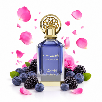 A blue glass perfume bottle with a gold cap and Arabic text reading 'بلوبيري مسك' and 'BLUEBERRY MUSK', surrounded by blueberries, blackberries, pink rose petals, and a pink rose on a white background. The brand name 'ADYAN By Anfar' is visible on the bottle.