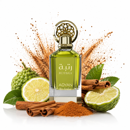 A bottle of ADYAN Anfar Ruthbah perfume with a gold cap, surrounded by cinnamon sticks, lime halves, green kumquat fruits, and a powder explosion on a white background.