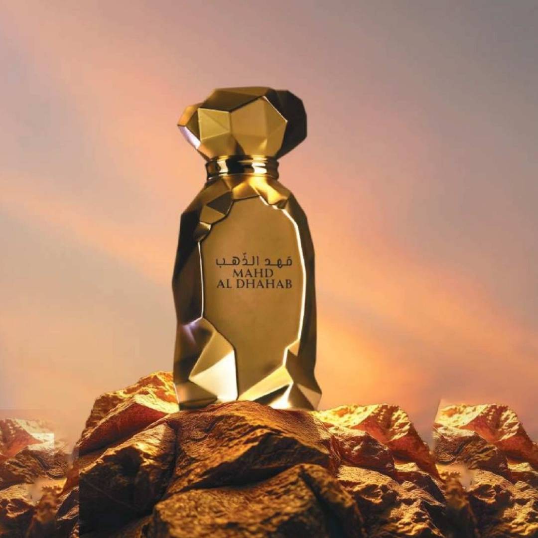 Arabiyat Prestige Mahd Al Dhahab EDP 100ml bottle with sunset background