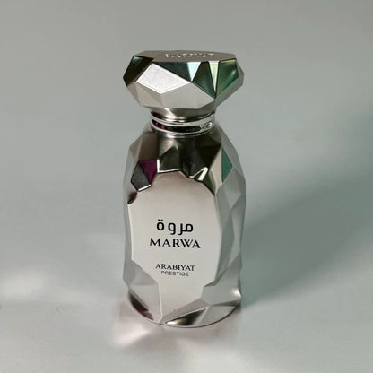 Arabiyat Prestige Marwa Eau de Parfum 100ml for Men bottle on wooden table indoors