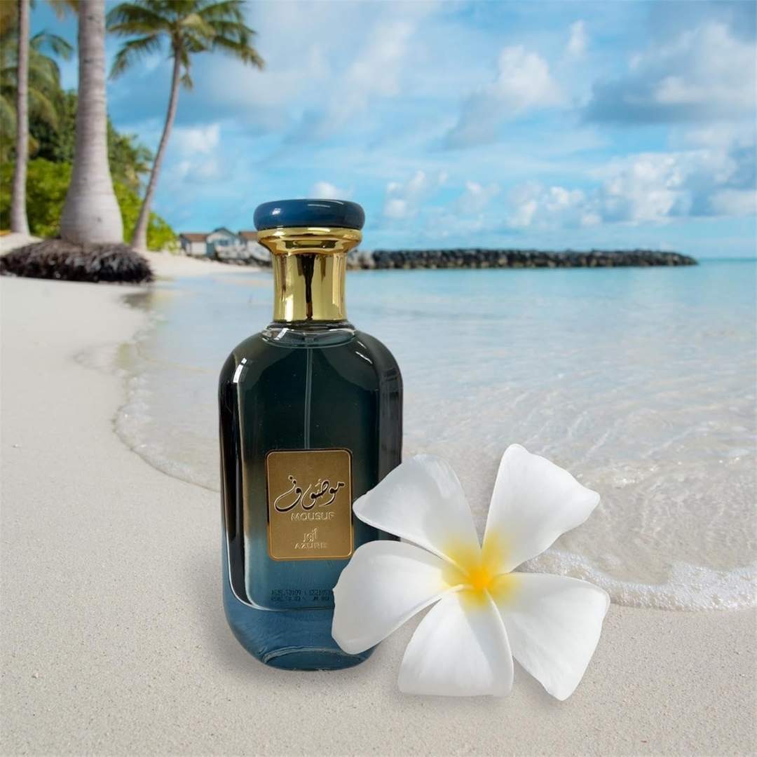 Ard Al Zaafaran Mousuf Azure Unisex EDP 100ml bottle on tropical beach with white flower