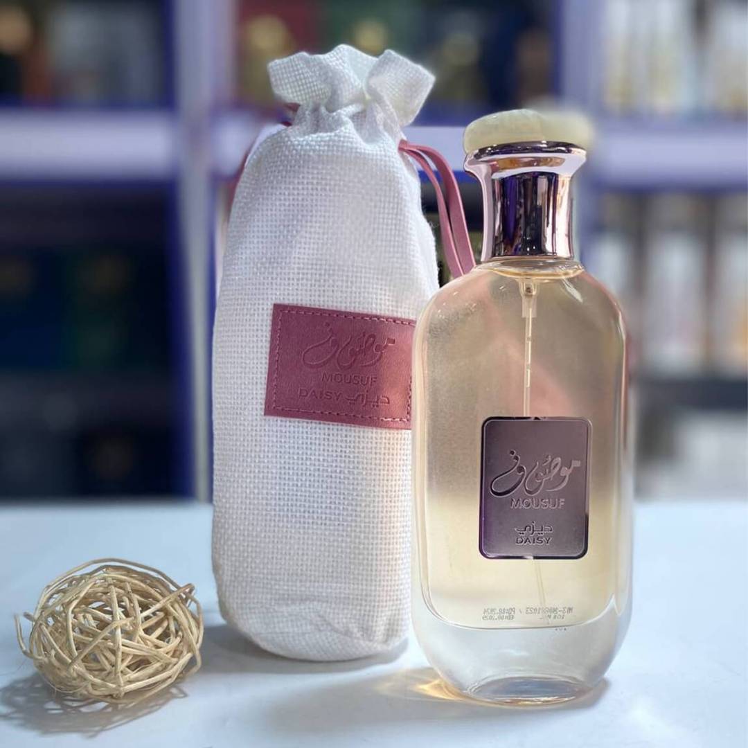 Ard Al Zaafaran Mousuf Daisy Perfume 100ml EDP For Women bottle and pouch on table indoors