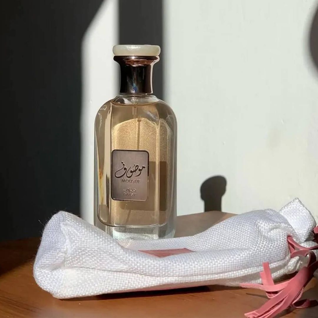 Ard Al Zaafaran Mousuf Daisy Perfume 100ml EDP For Women bottle standing beside open pouch