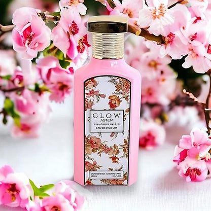 Asten Glow Glamorous Garden 100ml EDP bottle with pink blossoms background