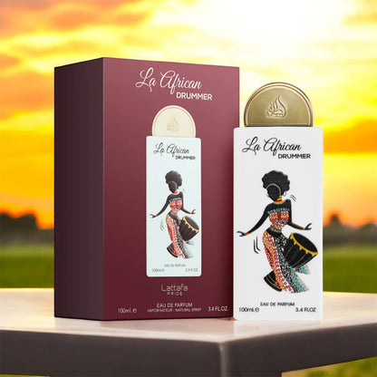 La African Drummer perfume bottle and packaging on a table with a sunset background