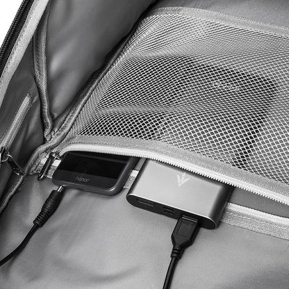 Portable charger plugged into a backpack with a smartphone on top best travel laptop backpack multi-functional