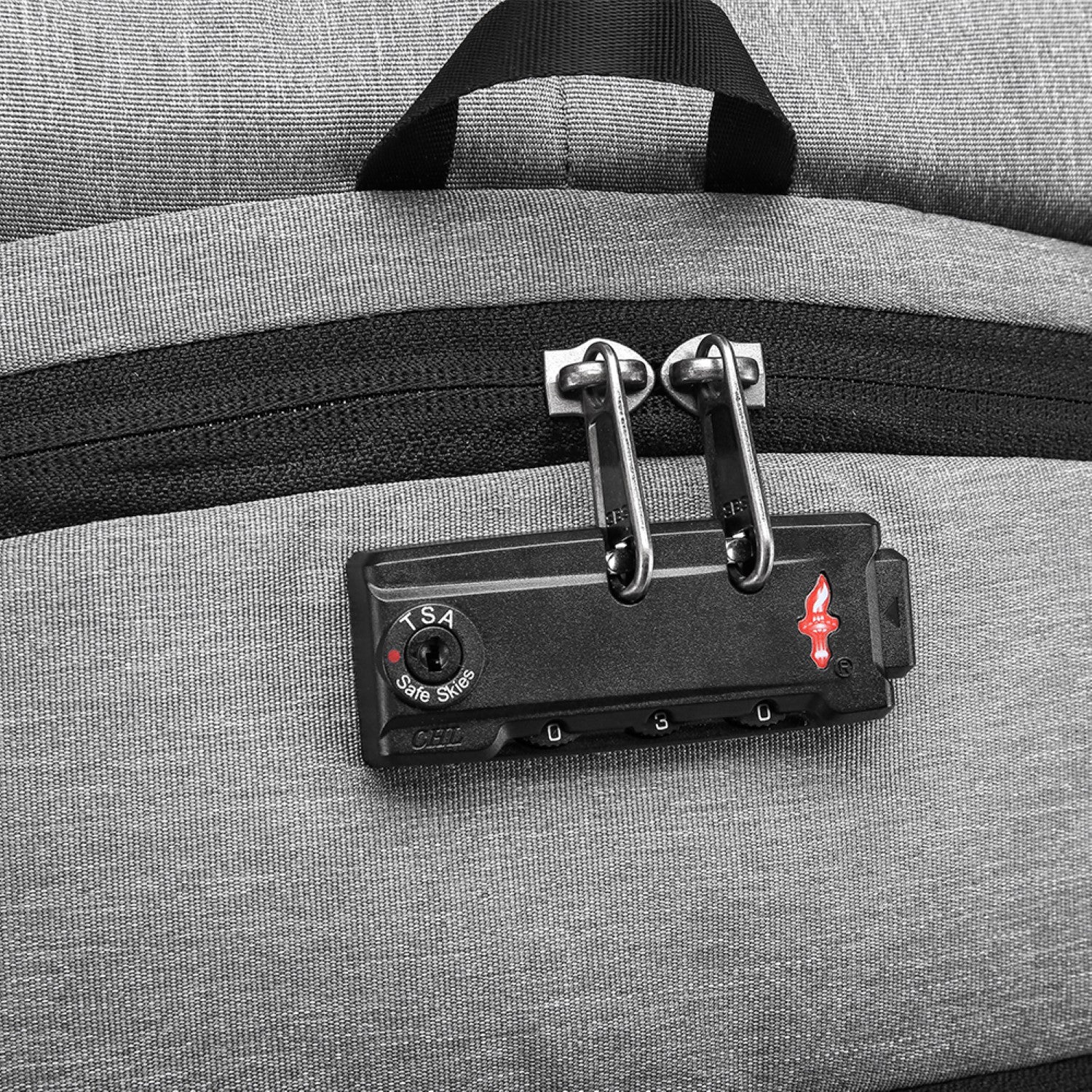 Close-up of a gray suitcase with a TSA-approved lock on a matching gray background best travel laptop backpack multi-functional