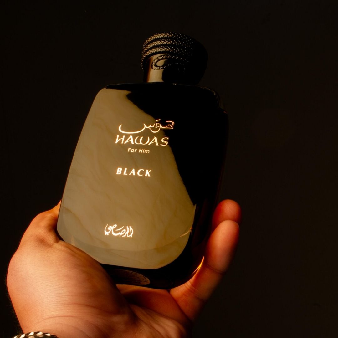Rasasi Hawas Black Eau de Parfum 100ml bottle in hand on dark background