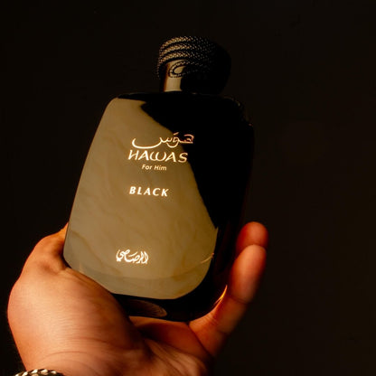 Rasasi Hawas Black Eau de Parfum 100ml bottle in hand on dark background