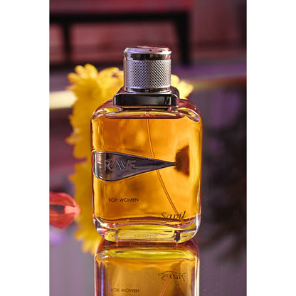 Rave Women Eau de Parfum bottle in vibrant orange light