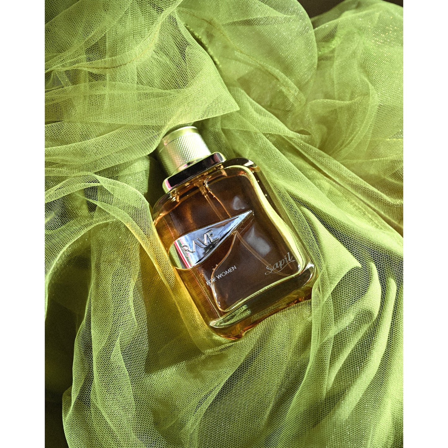Rave Women Eau de Parfum bottle on green fabric
