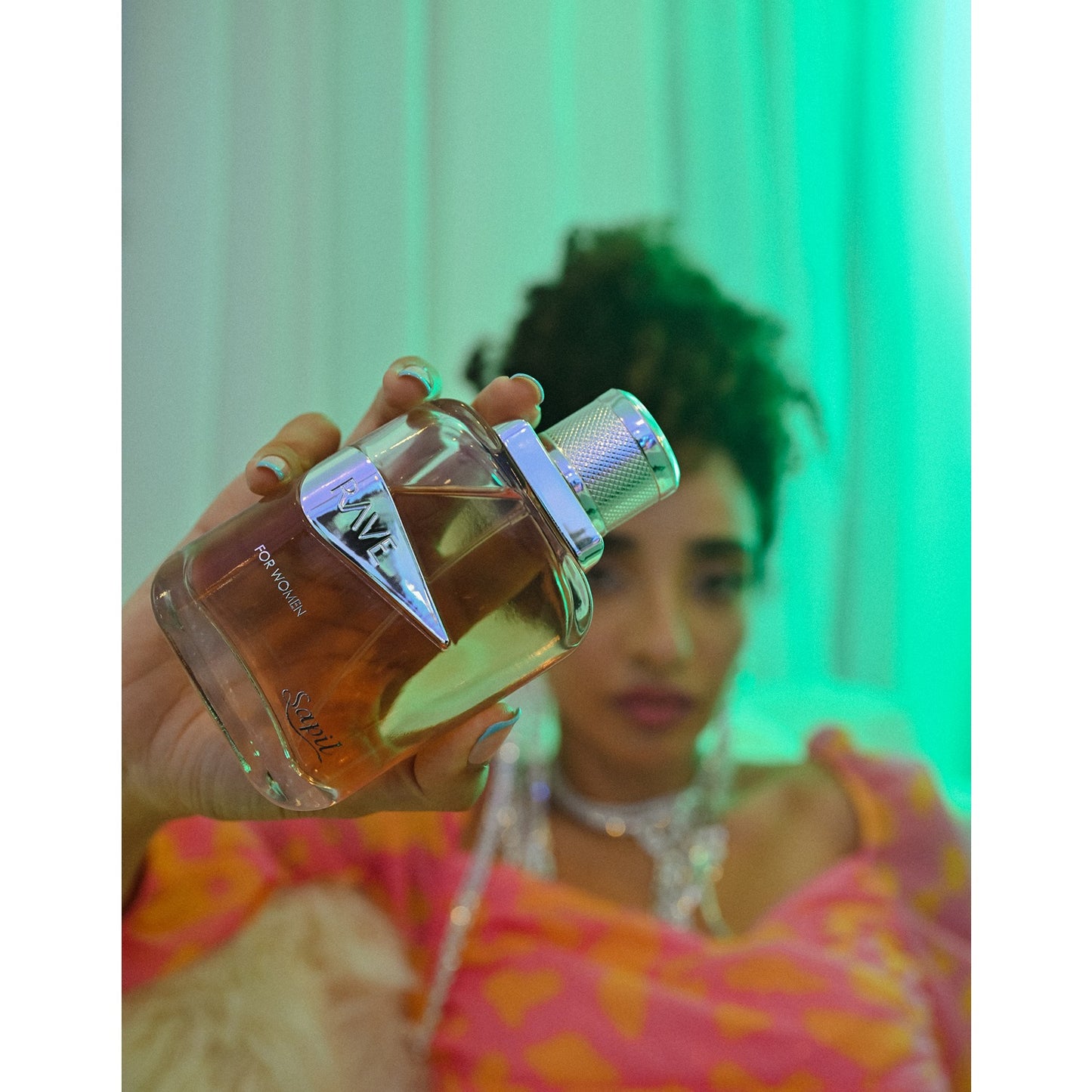 Sapil Rave Women Eau de Parfum held by model in green light