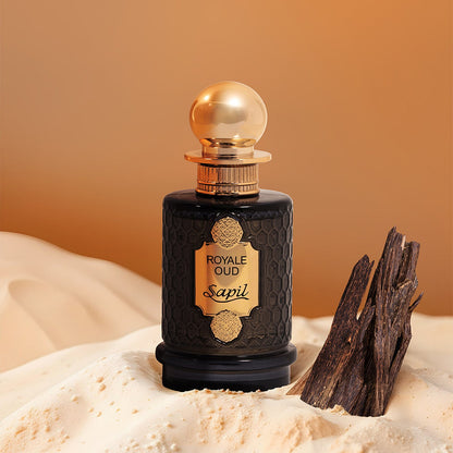 Sapil Royale Oud bottle on sand with oud wood pieces