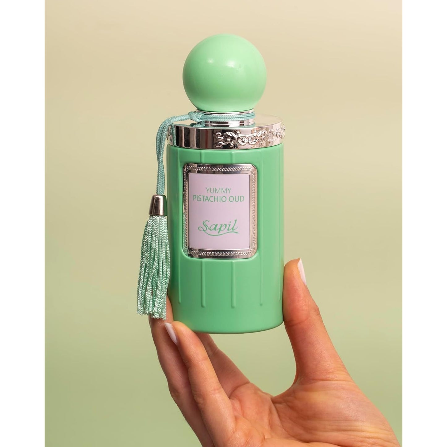 Sapil Yummy Pistachio Oud bottle held in hand