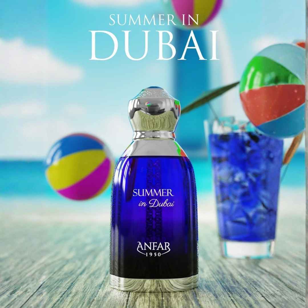 Anfar Summer in Dubai perfume bottle displayed on a beach scene with colorful beach balls and tropical drink, luxury Arabian summer fragrance by Anfar 1950.