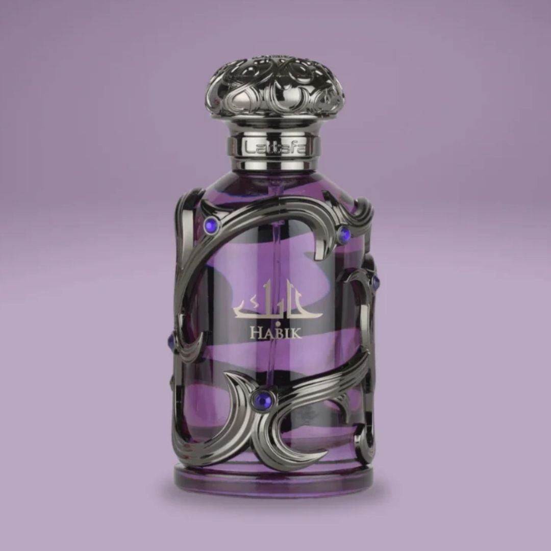 Lattafa Habik for Him men's perfume bottle in deep purple glass with silver ornate detailing displayed on a soft purple background, highlighting a luxury masculine fragrance.