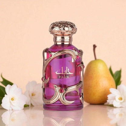 Lattafa Habik pink luxury perfume bottle displayed with pear fruit and white flowers, highlighting a fruity floral fragrance with fresh pear notes.