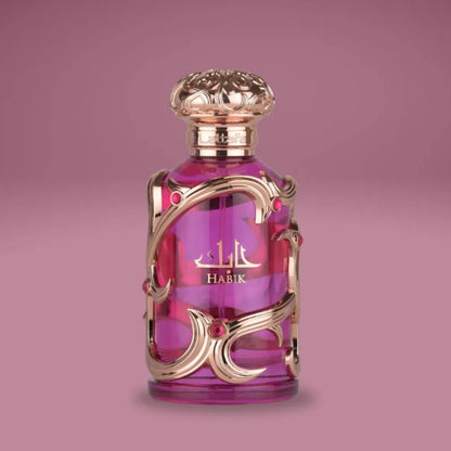 Lattafa Habik luxury pink perfume bottle with ornate gold detailing displayed on a soft pink background, highlighting an elegant romantic floral fragrance.