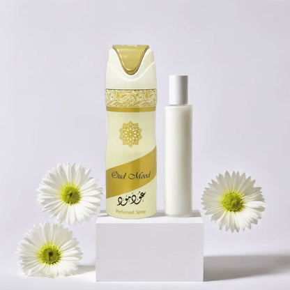 Lattafa Oud Mood perfumed body spray with luxury oud fragrance displayed with white flowers on a minimal white background.