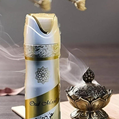 Lattafa Oud Mood perfumed deodorant body spray with rich oud fragrance displayed beside a traditional incense burner with aromatic smoke.
