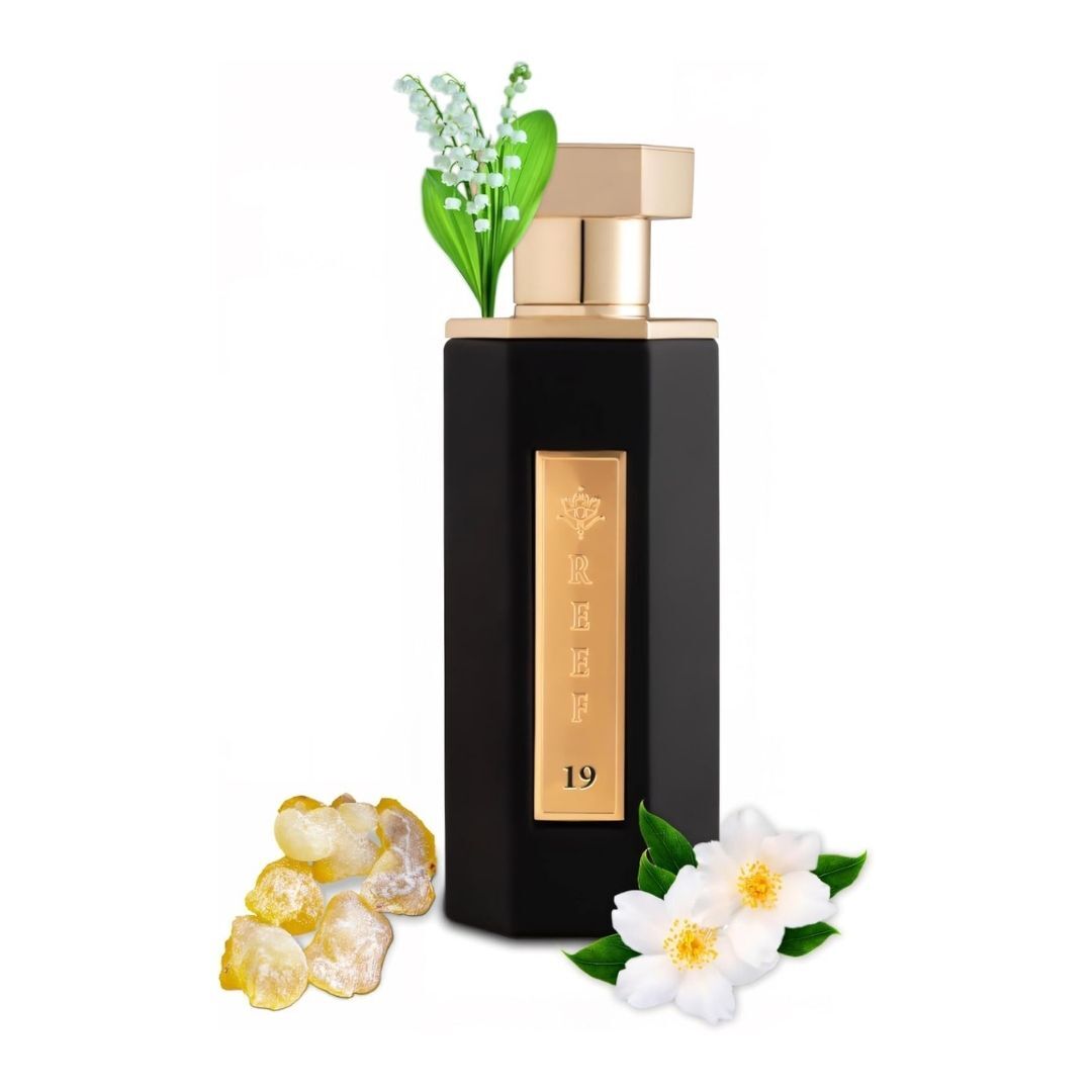Reef 19 luxury perfume bottle with gold cap and black design, displayed with white floral notes and amber resin representing elegant Arabian fragrance ingredients
