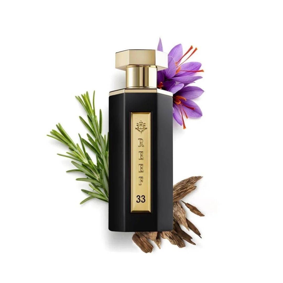 Reef 33 luxury black and gold perfume bottle displayed with saffron flower, rosemary leaves, and oud wood, representing a rich woody floral fragrance composition.