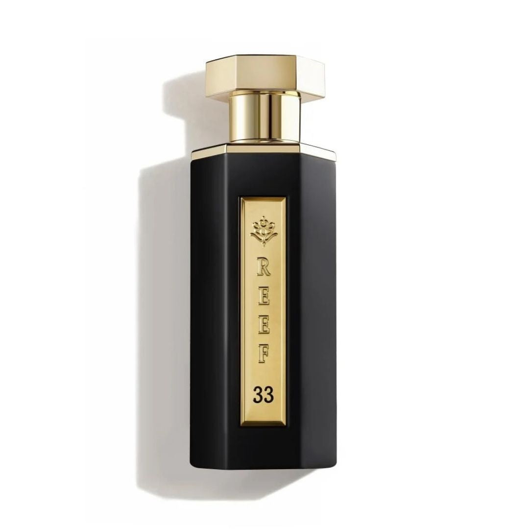 Reef 33 unisex eau de parfum 100ml in a sleek matte black bottle with a gold plaque and cap, photographed on a clean white background with premium luxury styling.
