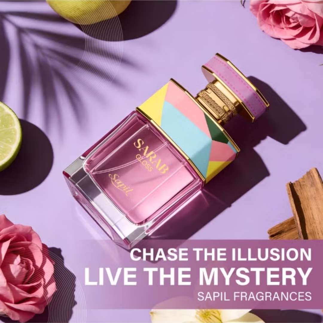 Sapil Sarab Gloss perfume bottle with colorful geometric cap on purple background with roses and citrus, “Chase the Illusion Live the Mystery” fragrance campaign.