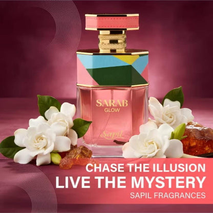 Sapil Sarab Glow Eau De Parfum luxury perfume bottle surrounded by white flowers and resin with slogan “Chase the Illusion Live the Mystery” fragrance by Sapil.