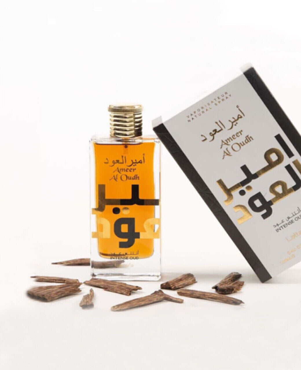 Lattafa Ameer Al Oudh Intense Oud Eau De Parfum - 100ml bottle box with oud wood on table
